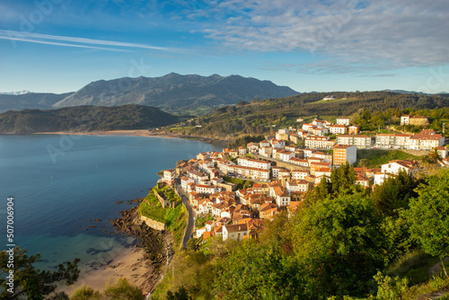 village of Lastres in Asturias, northern Spain. fishing village with the mountains in the background at sunrise. European tourism. © Berto