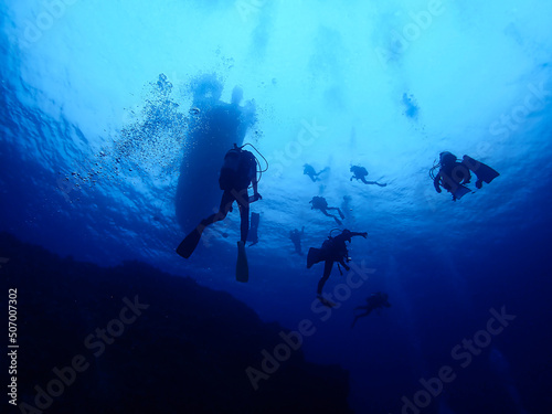 Looking up Scuba divers and a Boat