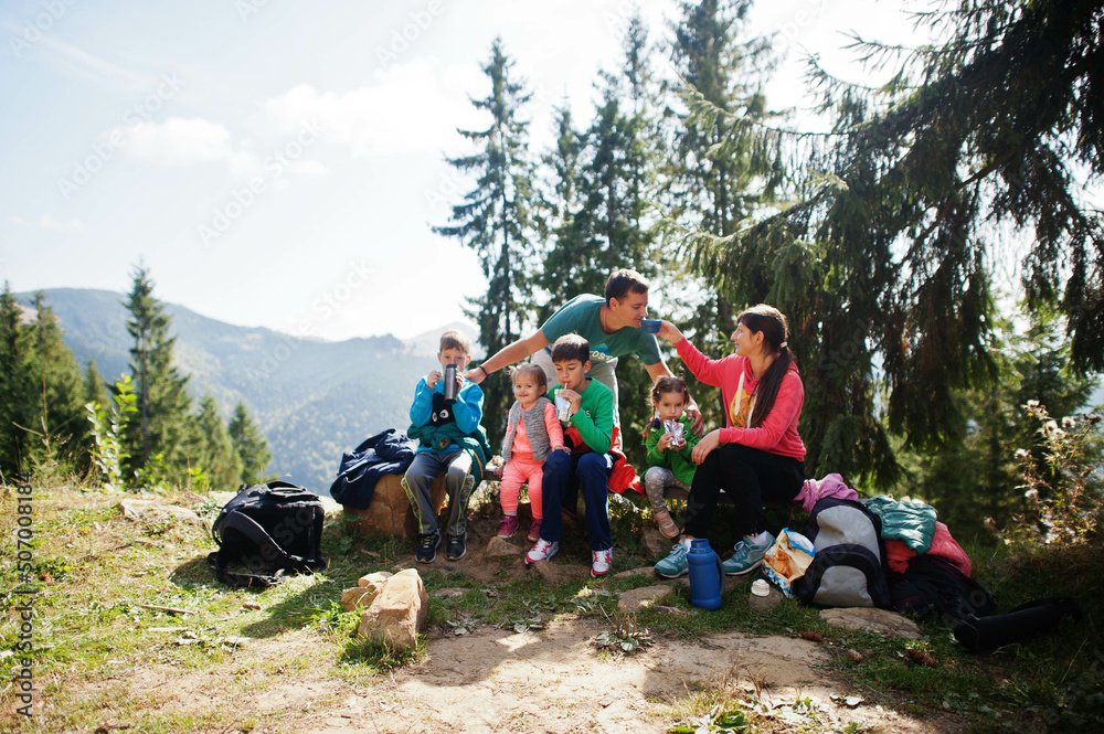 Fototapeta premium Family with four kids resting in mountains. Travel and hiking with childrens.