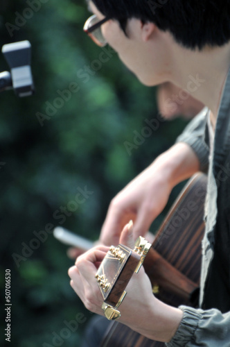 a chinese yong boy playing guitar