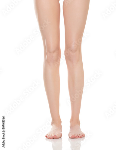 Front view of beautifully cared women's legs and feet on white background