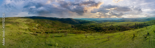 Meadows with a plant in a valley with fields against the background of the daytime sky in Bulgaria