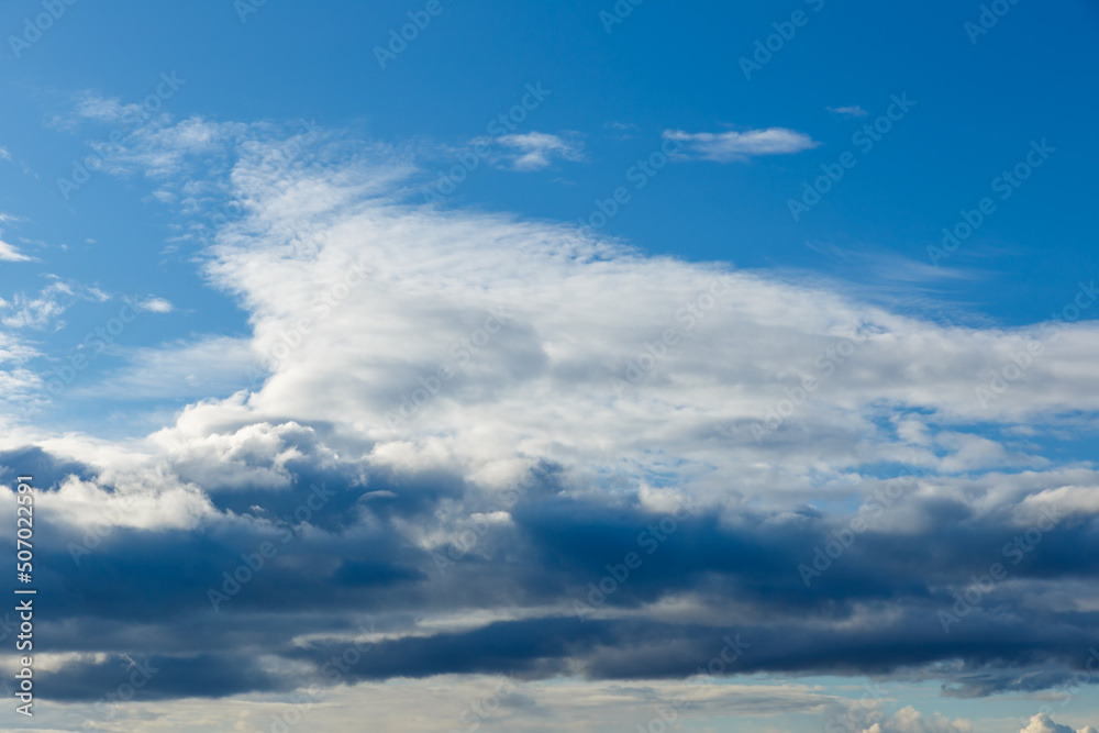 White and black clouds in the blue sky. Sky background.