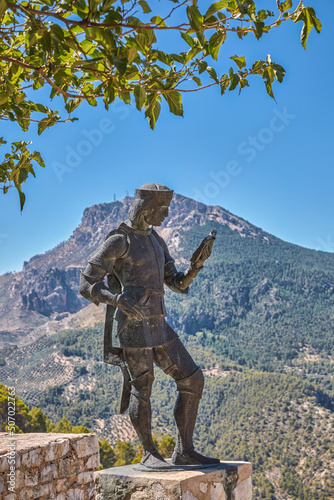 monument to a medieval man with mountains in the background in segura de la sierra, Jaén.