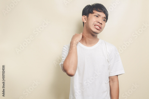 asian man wearing white t-shirt backache isolated background