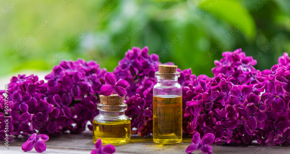 Lilac essential oil in a small bottle. Selective focus. Stock Photo