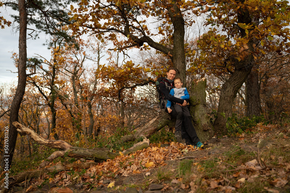 Mum and child are walking along the mountain hiking trail. Family spending time. Mum and child are walking along the mountain hiking trail. Family spending time.