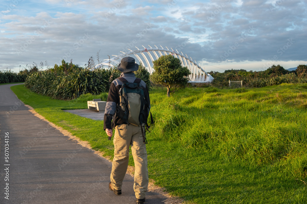 Man walking New Plymouth Coastal Walkway with Te Rewa Rewa bridge in sight