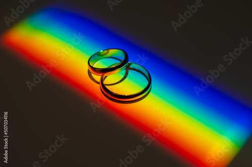 Rainbow beam on wedding rings. lgbt flag. 