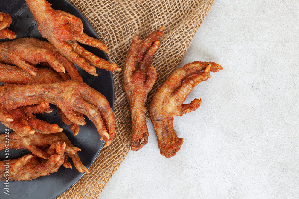 South African township delicacy, fried chicken feet or walkie talkies with  onion and sauce Stock Photo | Adobe Stock