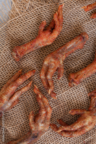 South African township delicacy,  fried chicken feet or walkie talkies with onion and sauce photo