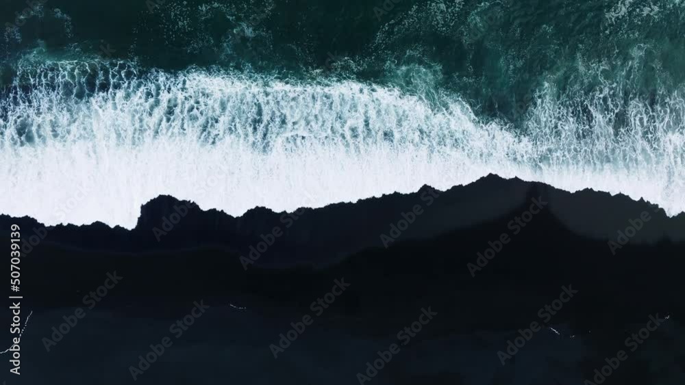 Iceland black sand beach with huge waves at Reynisfjara Vik. Aerial cinematic 4k video. Beautiful Iceland nature coastline from above.