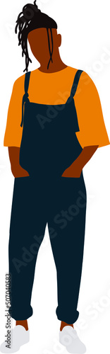 A black guy with black dreadlocks is standing in an orange t-shirt and blue overalls