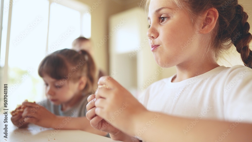 children eat burgers. sun fast food burger. a group of small children in the kitchen greedily eat fast food burgers. big family small kids having breakfast in the morning in the kitchen eating burger children eat burgers. sun fast food burger. a group of small children in the kitchen greedily eat fast food burgers. big family small kids having breakfast in the morning in the kitchen eating burger