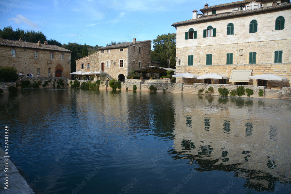 Bagno Vignoni – Tuscany - Italy – September 26, 2015: the village is located in Val d'Orcia and its square is a thermal swimming pool surrounded by stone houses and a wash house.