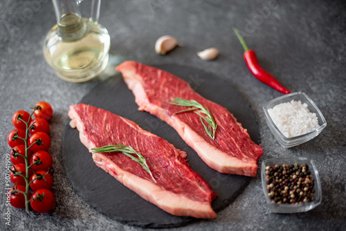 raw Picanha steak on stone background with spices photo