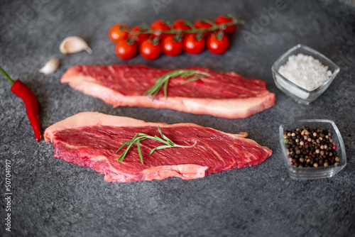 raw Picanha steak on stone background with spices photo