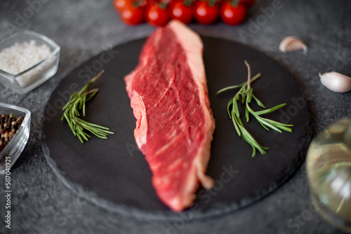 raw Picanha steak on stone background with spices photo