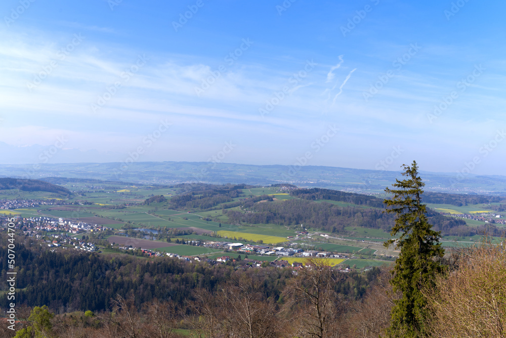 Obraz premium Aerial view over rural landscape seen from local mountain Uetliberg on a blue cloudy spring day. Photo taken April 21st, 2022, Zurich, Switzerland.