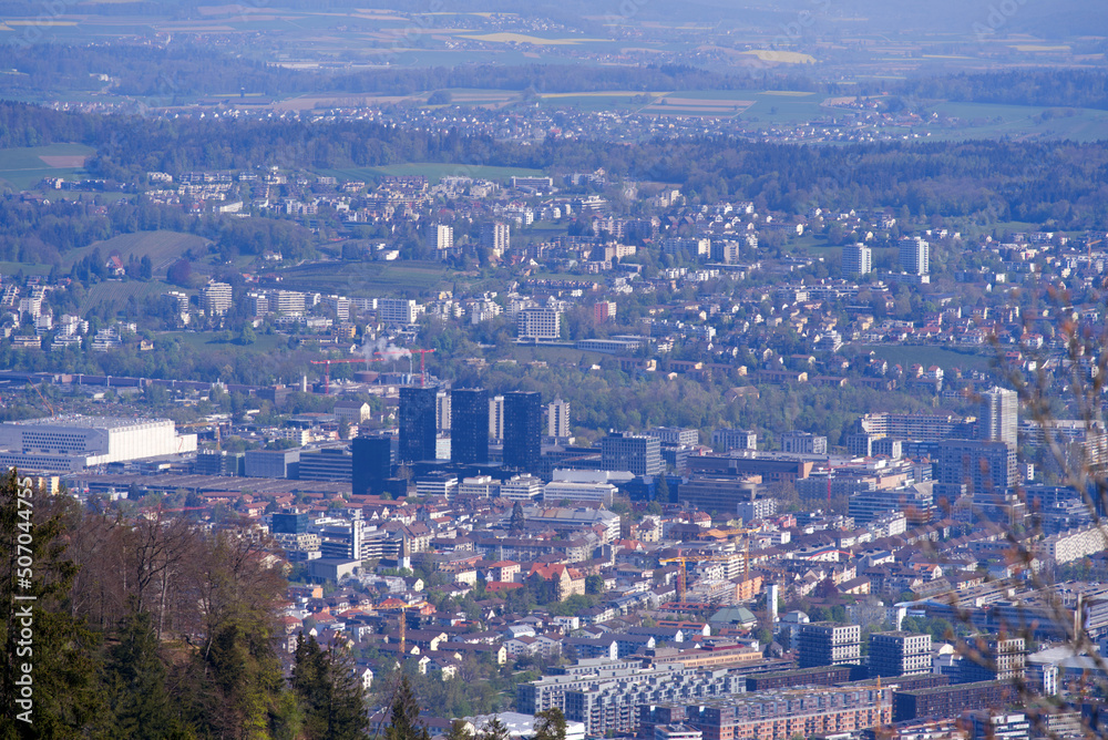 Aerial view over City of Zürich seen from local mountain Uetliberg on a sunny spring day. Photo taken April 21st, 2022, Zurich, Switzerland.