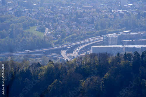Aerial view over City of Zürich with highway junction on a beautiful spring day with blue cloudy sky background. Photo taken April 21st, 2022, Zurich, Switzerland.