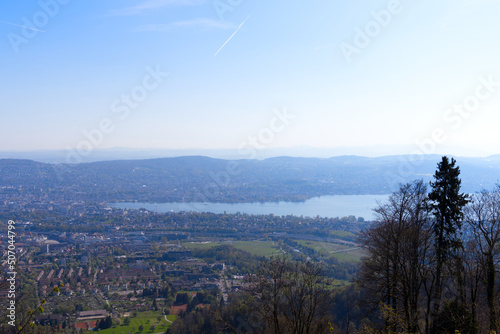 Aerial view over City of Zürich with bay of Lake Zürich on a beautiful spring day with blue cloudy sky background. Photo taken April 21st, 2022, Zurich, Switzerland. © Michael Derrer Fuchs