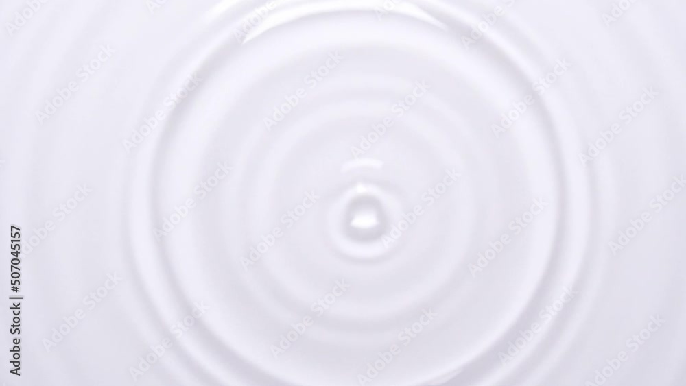 Top view slow motion scene of waterdrop dropping on a surface of water isolated on white background, raindrop falling down to the ground, clean drink concept, science wavelength experiment laboratory