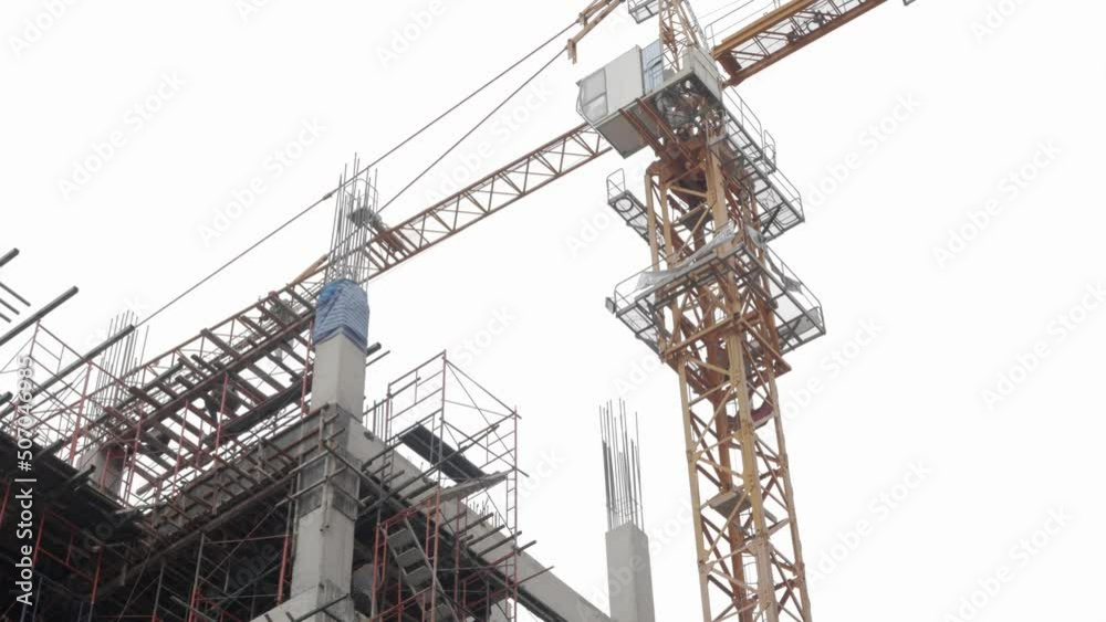 view at construction site building new apartment with tower crane view at construction site building new apartment with tower crane