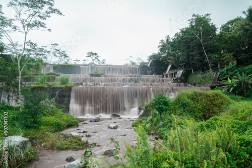 Grojogan watu purbo in sleman, Yogyakarta, Indonesia which has 6 levels of water dam is a popular attraction for tourists photo