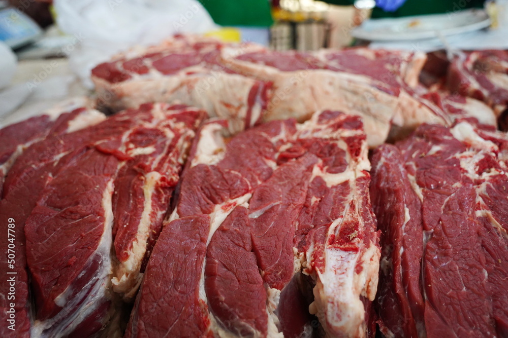 Almaty, Kazakhstan - 03.25.2022 : Different parts of meat are prepared for sale on the open market.