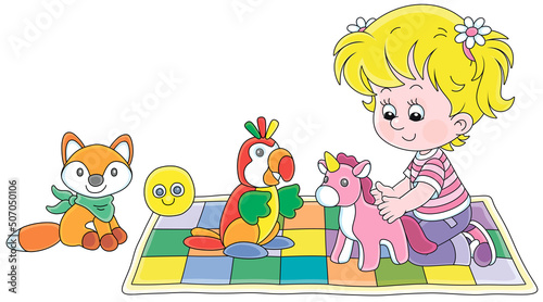 Happy little girl playing with a funny soft toy unicorn  a parrot and a fox on a colorful checkered carpet in a nursery  vector cartoon illustration isolated on a white background
