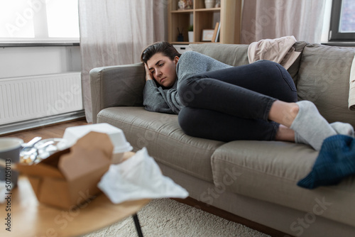mental health, psychological problem and depression concept - stressed woman lying on sofa at home