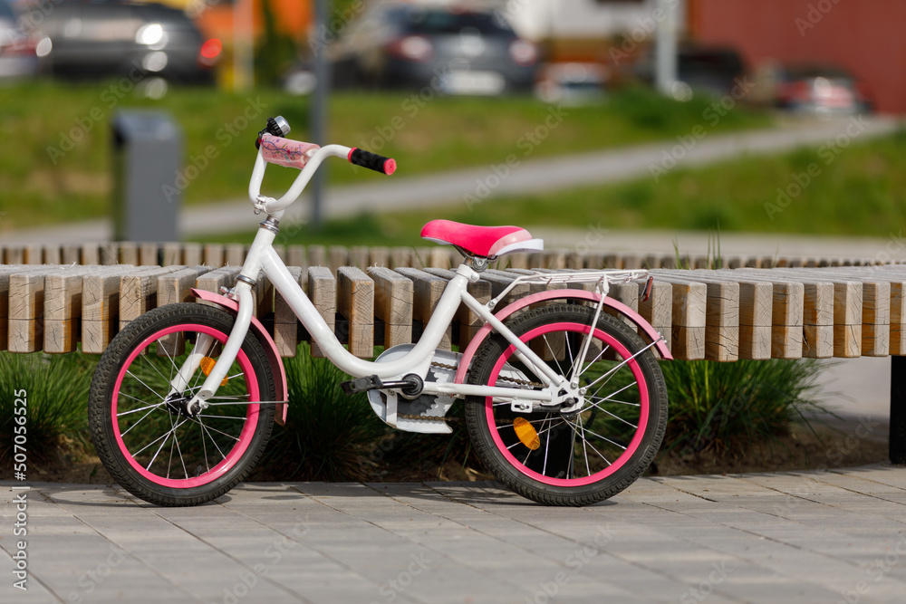 Modern children's bicycle in park on sunny day