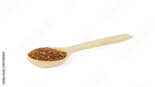 flax in wooden spoon on white background