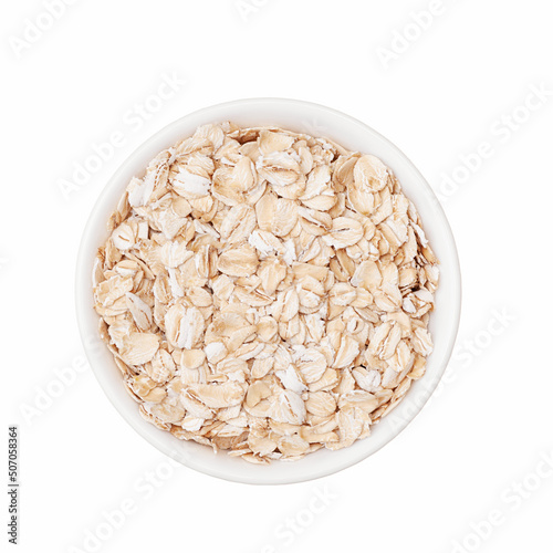 Oat flakes in white cup top view isolated on white background