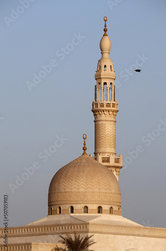 Minaret and dome of the mosque in Dubai at sunset