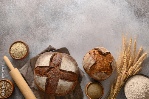 Wholegrain and hemp bread on gray background. View from above with copy space. photo