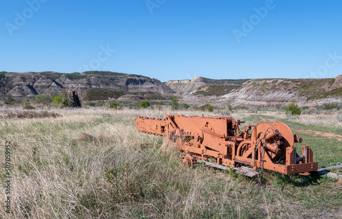 Coal cutter from an abandoned mine sitting in the Alberta badlands