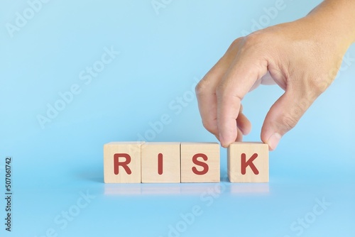 Hand building risk word in wooden blocks. Business risk management assessment and take risks concept.