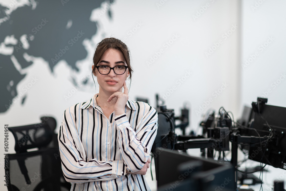 Fototapeta premium Portrait of businesswoman in casual clothes with glasses at modern startup open plan office interior. Selective focus 