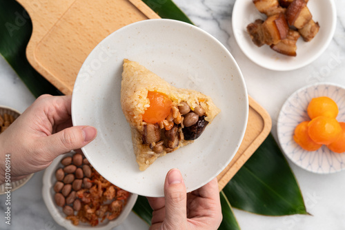 Zongzi. Rice dumpling for Dragon Boat Festival on bright marble table background with ingredient.