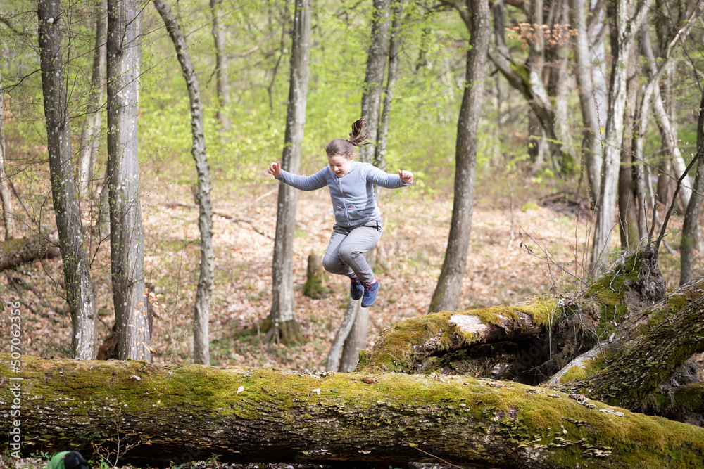 Girl jumping in the woods