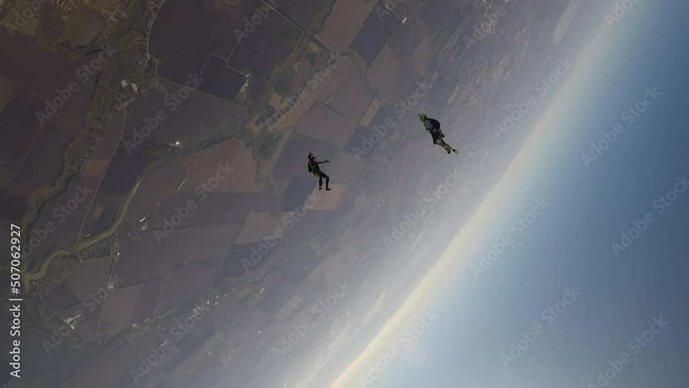 skydiving, acrobatics in the sky, a group of parachutists falling next