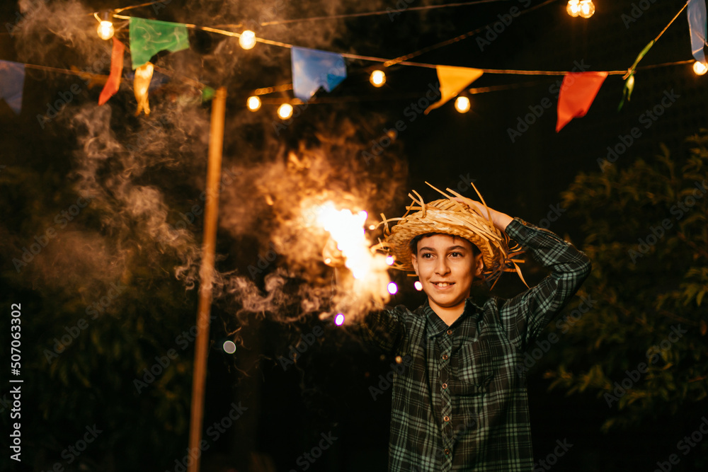 Child playing with fireworks during the traditional Festa Junina in Brazil. Child playing with fireworks during the traditional Festa Junina in Brazil.