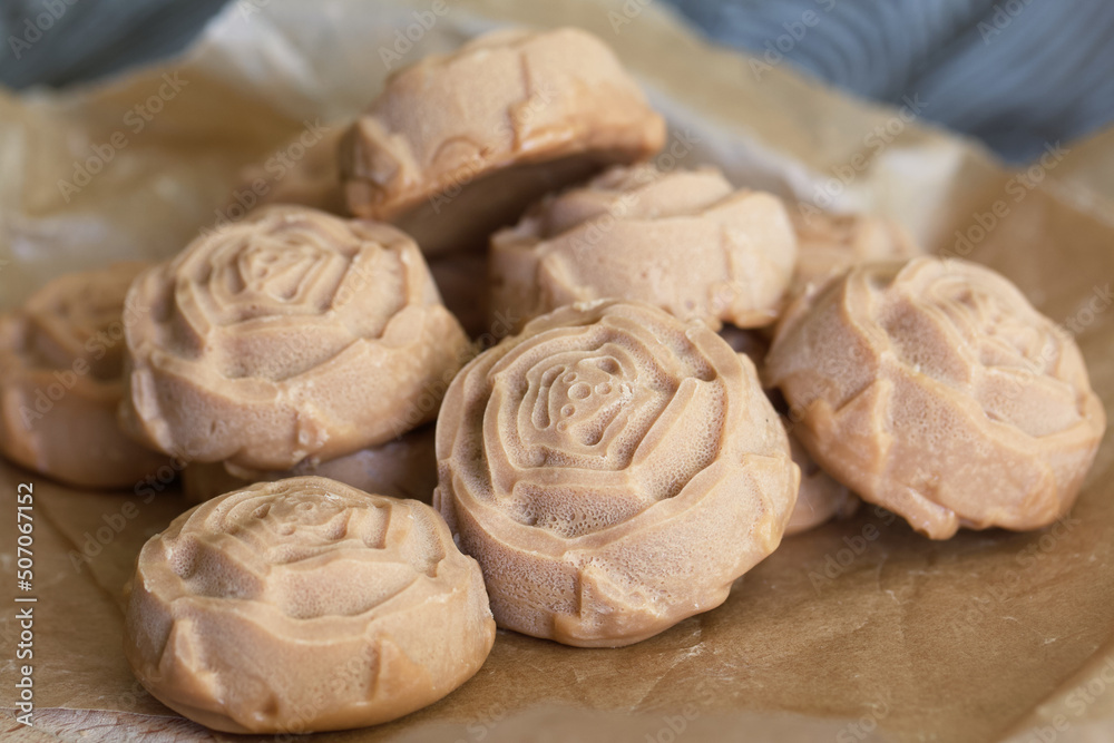 Fototapeta premium Candy cream toffee. In the form of flowers. Close-up, from above.