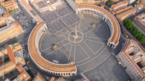 Aerial view of the colonnade and St. Peter's square located in the Vatican city. This state is an enclave within the city of Rome, Italy. The obelisk in the center is known as "The Witness".