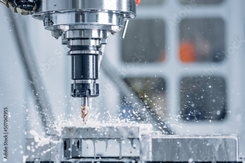 Working closeup CNC turning cutting metal Industry machine iron tools with splash water photo