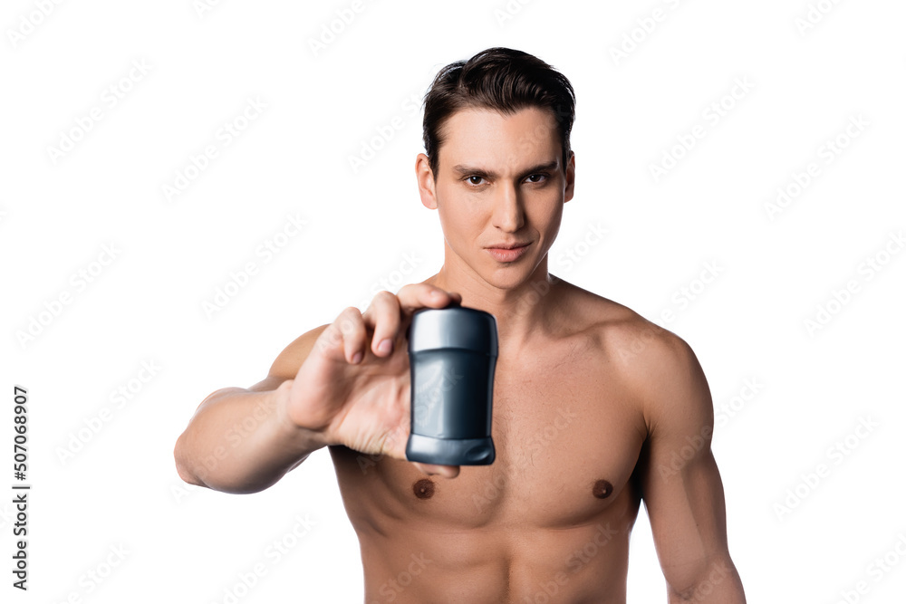 brunette man with perfect body holding dry deodorant isolated on white. brunette man with perfect body holding dry deodorant isolated on white.