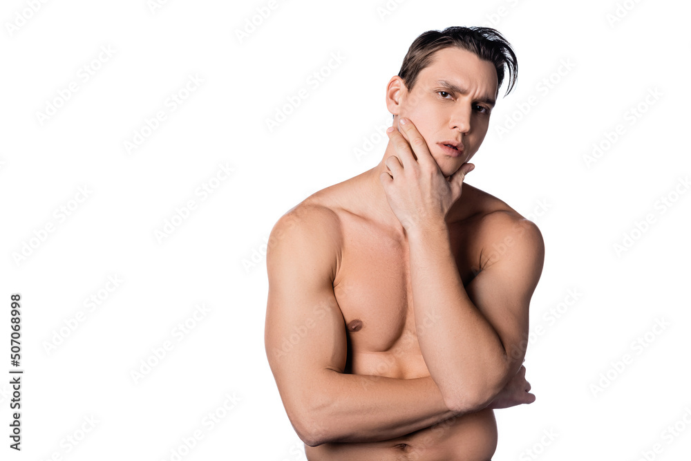Fototapeta premium shirtless man touching face and looking at camera isolated on white.