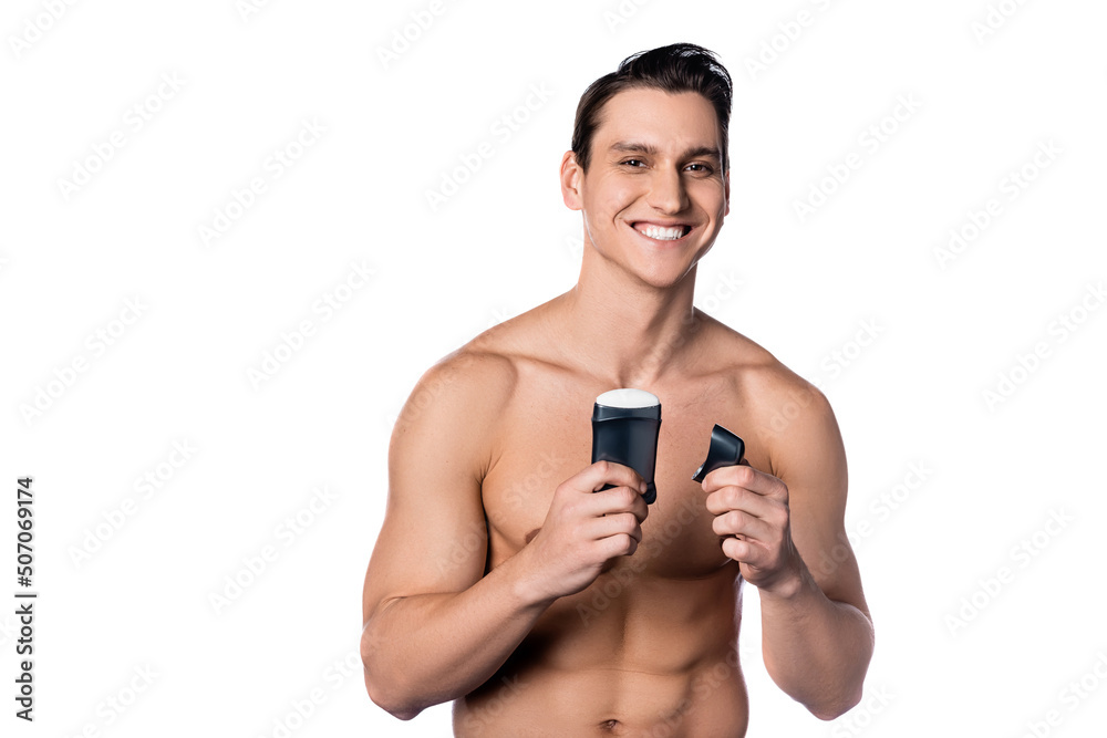 smiling man with muscular torso holding dry deodorant isolated on white. smiling man with muscular torso holding dry deodorant isolated on white.